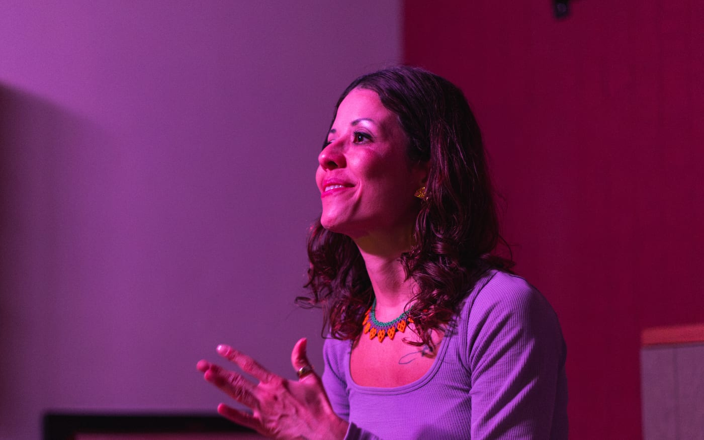 Rafaela Buena smiling and talking on stage while hosting Tummy Talks by Gigi